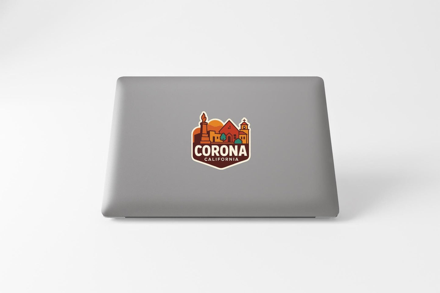a sticker with the text "CORONA CALIFORNIA" on a laptop.
