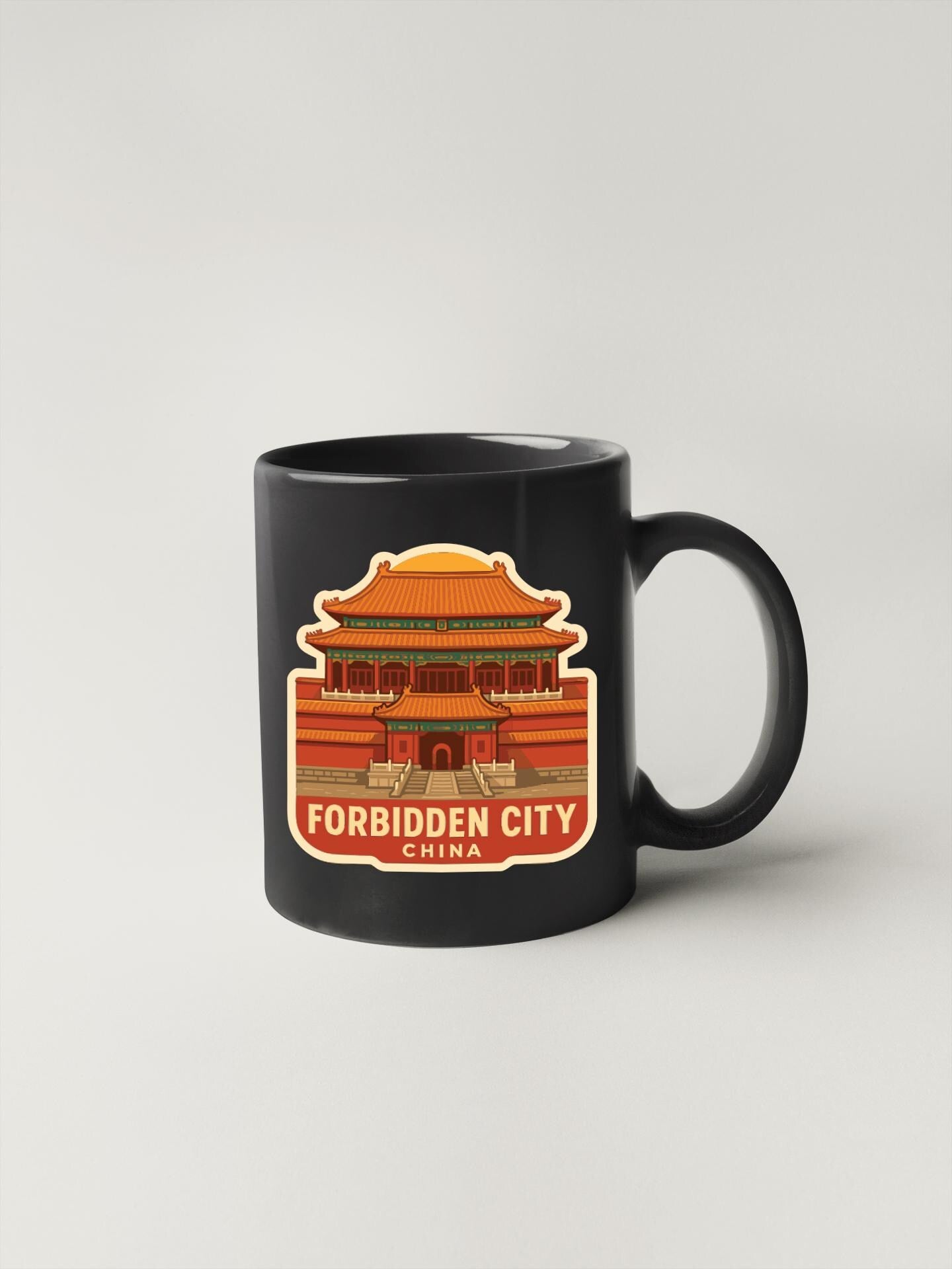 A black coffee mug with a sticker depicting the Forbidden City in Beijing, China.