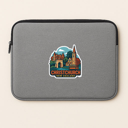 A gray laptop sleeve with a sticker depicting a cityscape and the text "Christchurch New Zealand" printed on it.
