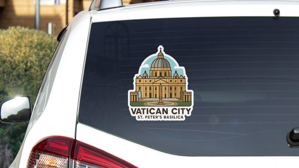 A sticker on the rear window of a car, depicting the Vatican City, with the text "VATICAN CITY St. Peter's Basilica" below it.