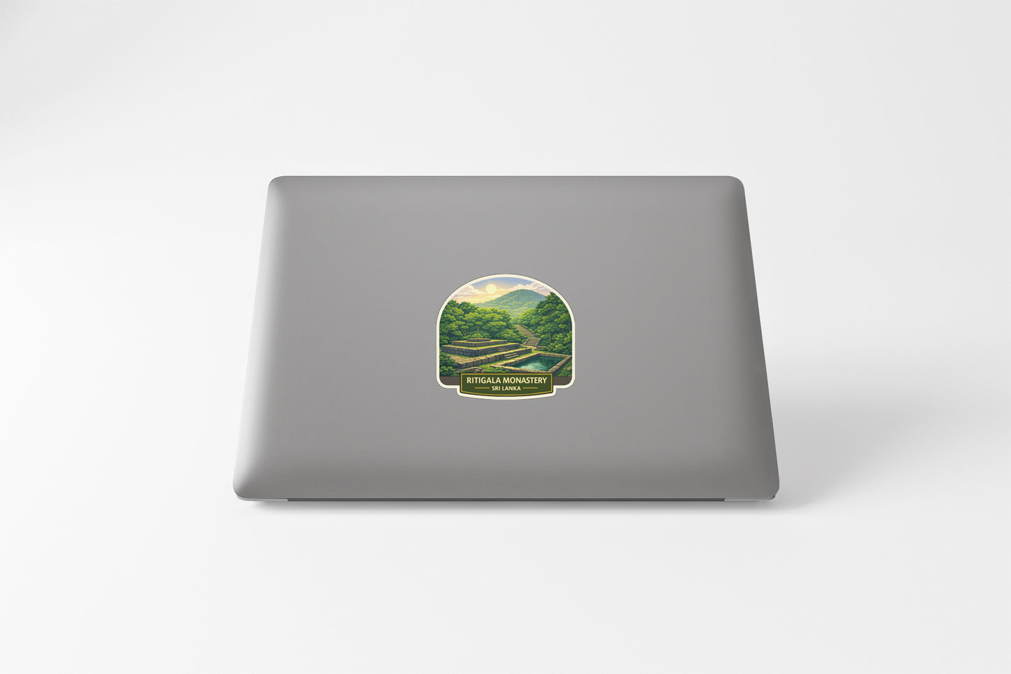 a sticker with a landscape scene on the back of a laptop.
