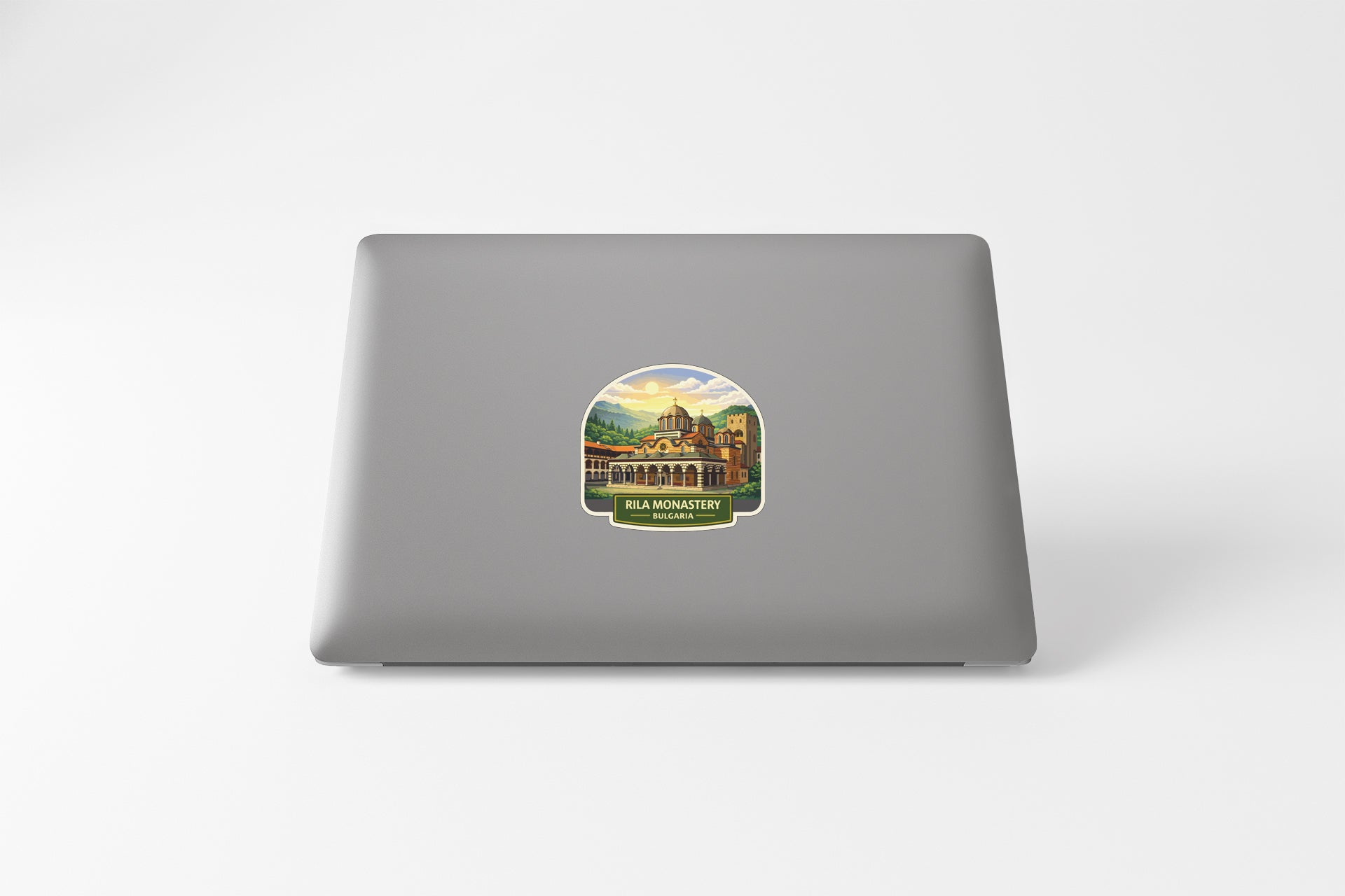 A sticker depicting a scenic view of a building or landmark, with the text "RUGBY MONASTERY" printed on it.