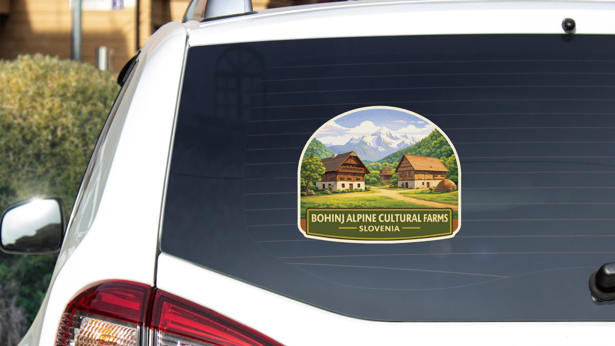 a sticker on the rear window of a car, depicting a scenic mountain landscape with traditional Swiss chalets.