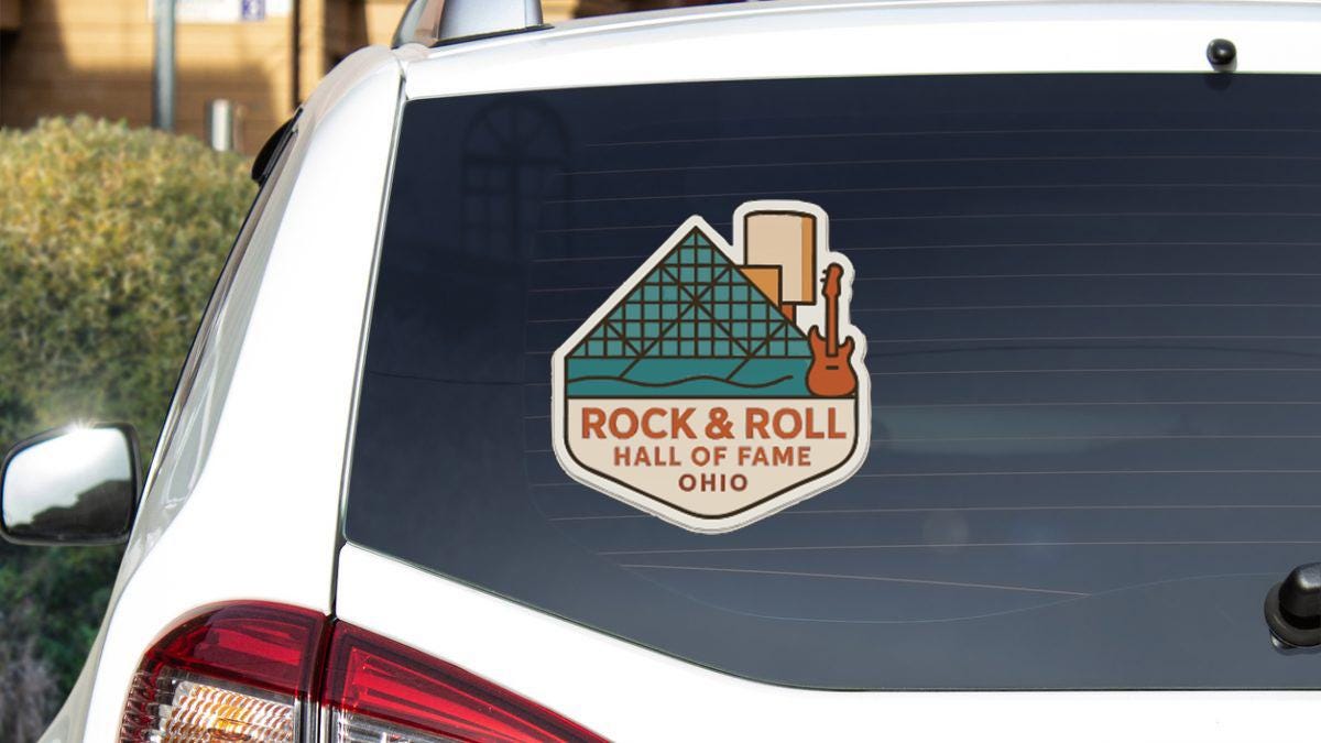 a sticker on the rear window of a car that says "Rock & Roll Hall of Fame Ohio".