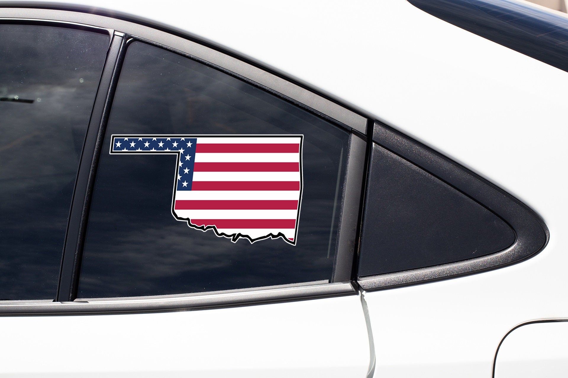an american flag sticker on a car window