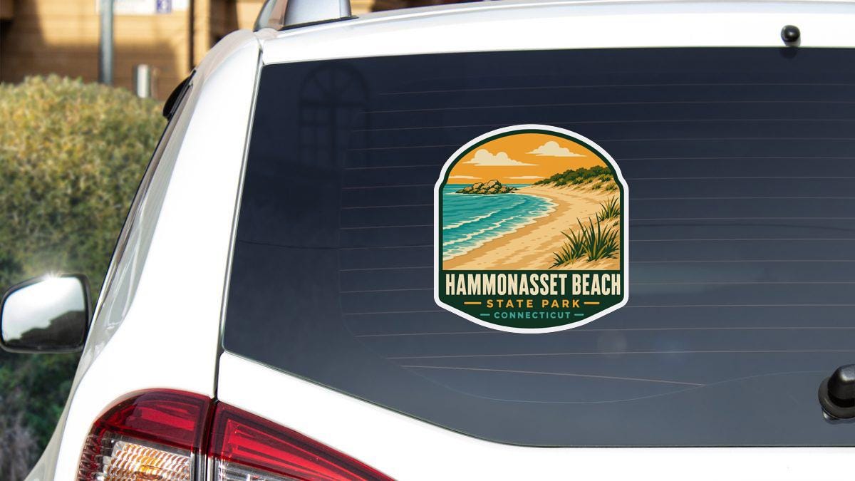 A sticker on the rear window of a white car, depicting a scenic beach landscape with a body of water and a sandy beach.