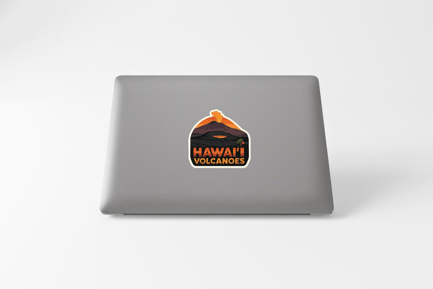 A sticker on the back of a laptop that says "HAWAII VOLCANOES".