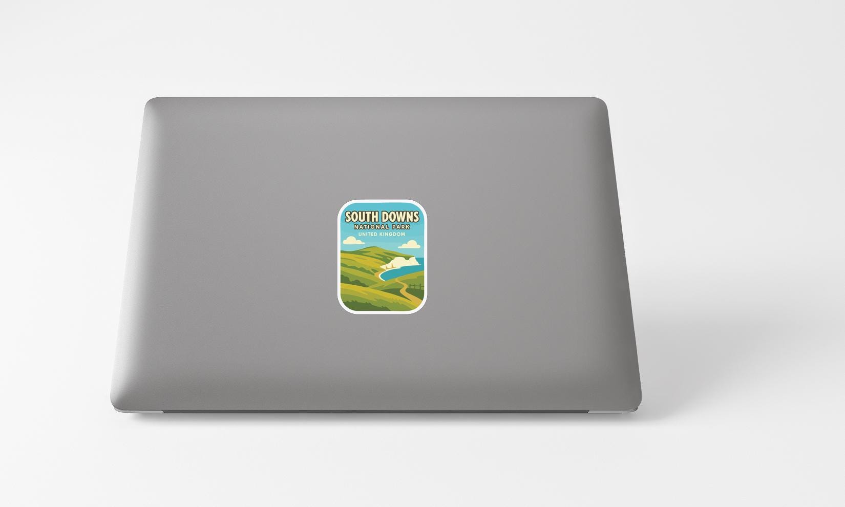 A sticker with a scenic landscape on a laptop.