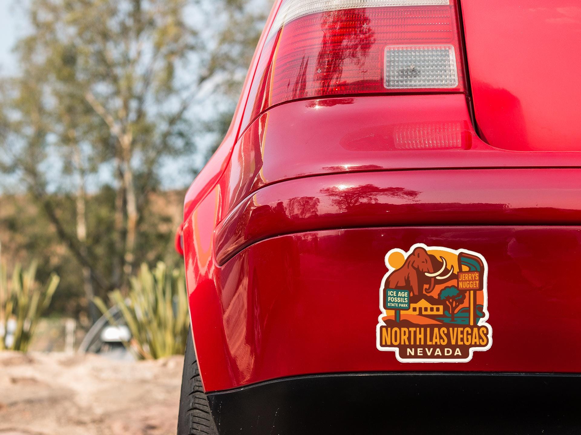 the rear end of a red car with a sticker on the trunk that says "NORTH LAS VEGAS NEVADA".