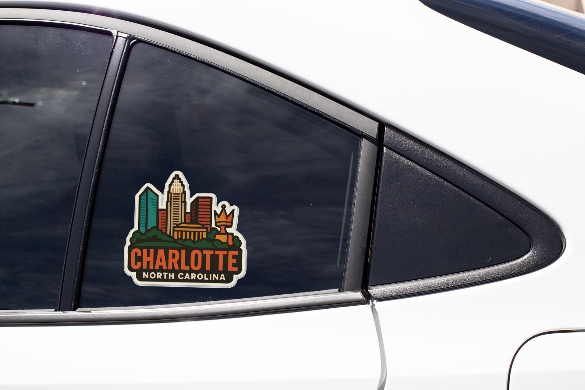 A sticker on the side of a car window that says "CHARLOTTE NORTH CAROLINA".