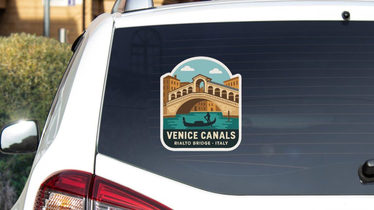 a sticker on the rear window of a car that displays the iconic Rialto Bridge in Venice, Italy.