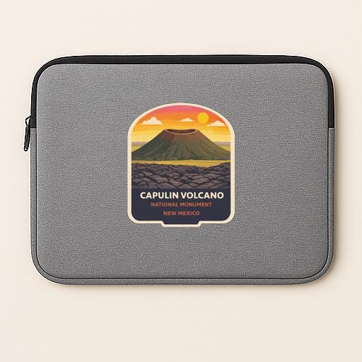 A gray laptop sleeve with a graphic design depicting the Capulin Volcano National Monument in New Mexico.