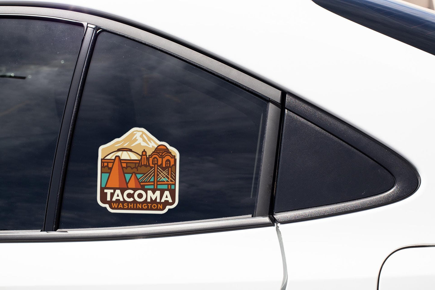 A sticker on the side of a car window that says "TACOMA WASHINGTON".