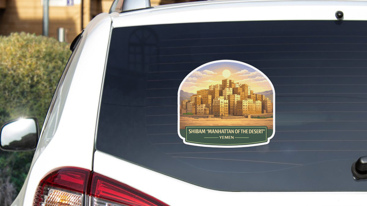 a sticker on the rear window of a car that depicts a cityscape with a desert-like environment.