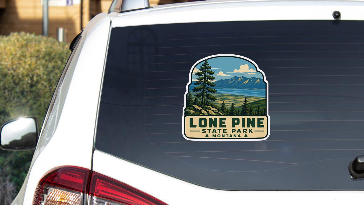 A sticker on the rear window of a vehicle that says "Lone Pine State Park & Montana".