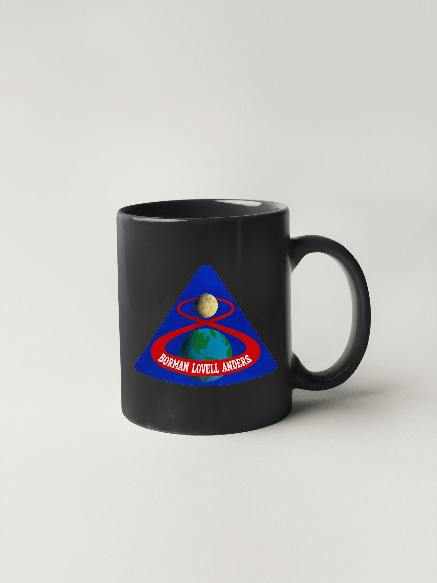 a black coffee mug with a blue triangle on it