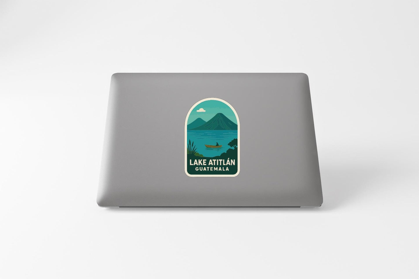 a sticker on a laptop that displays a scenic view of Lake Attila in Guatemala.