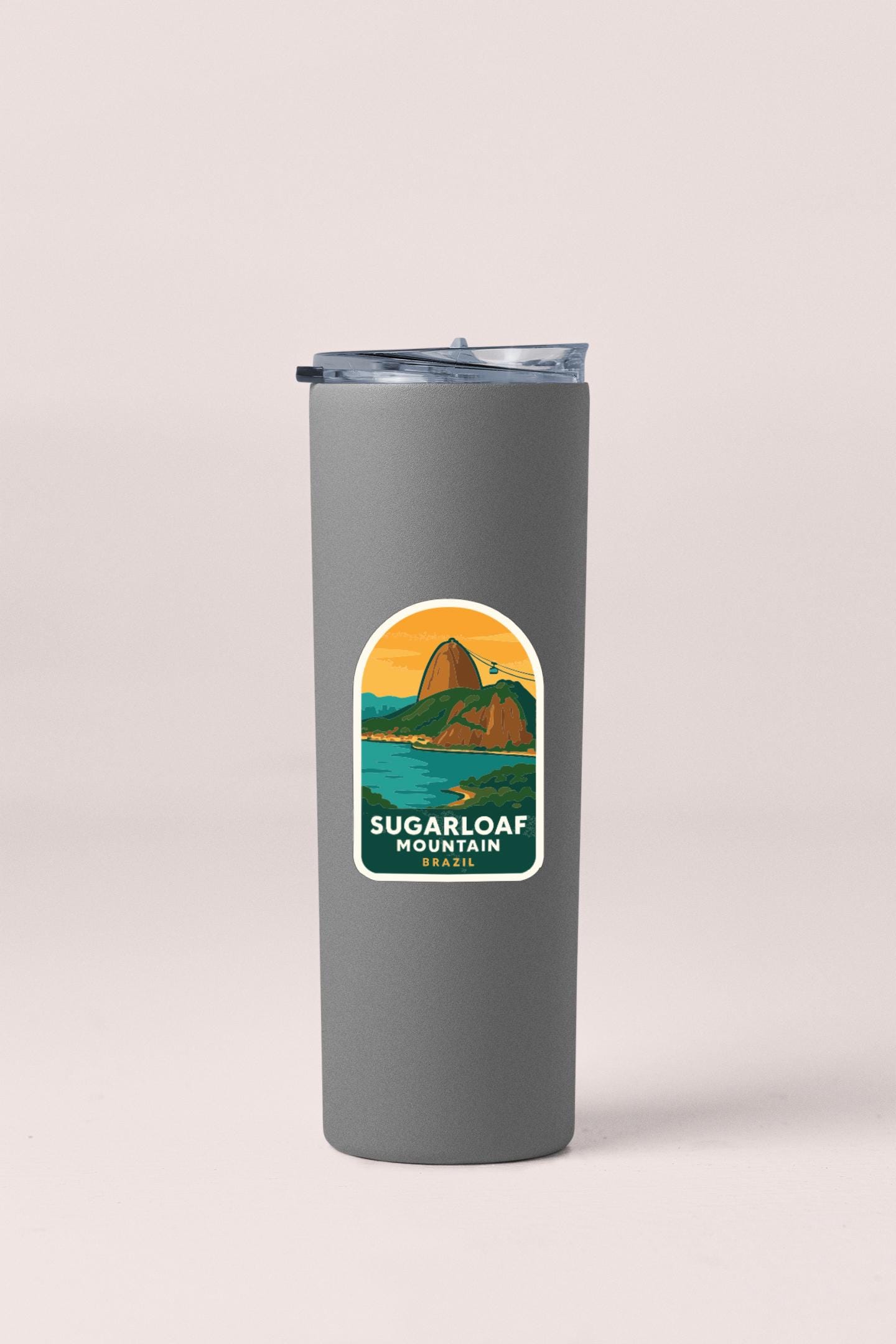 A gray insulated tumbler with a label that says "Sugarloaf Mountain" and features an illustration of a mountain landscape.