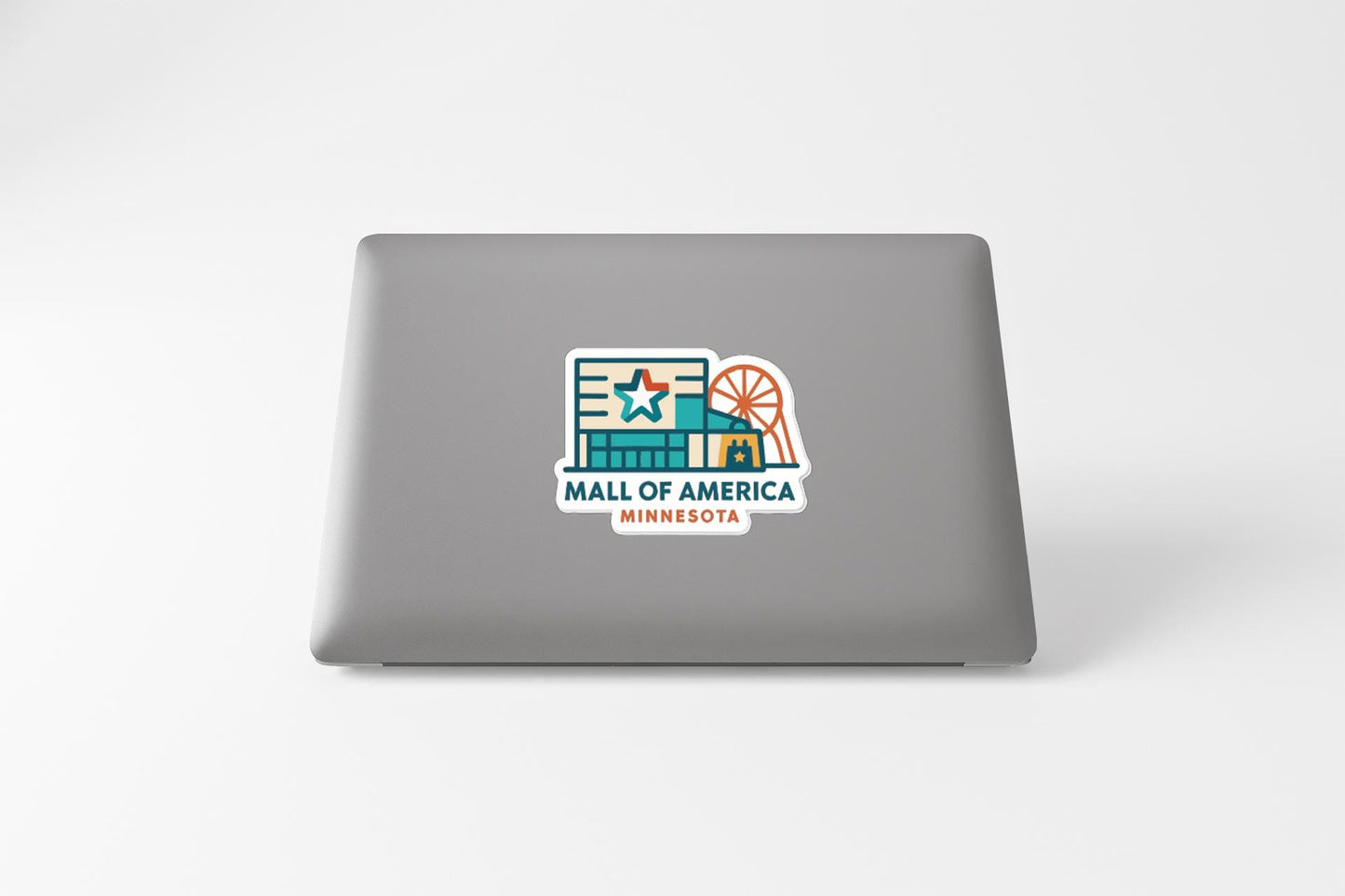 a sticker on the back of a laptop that says "MALL OF AMERICA MINNESOTA".