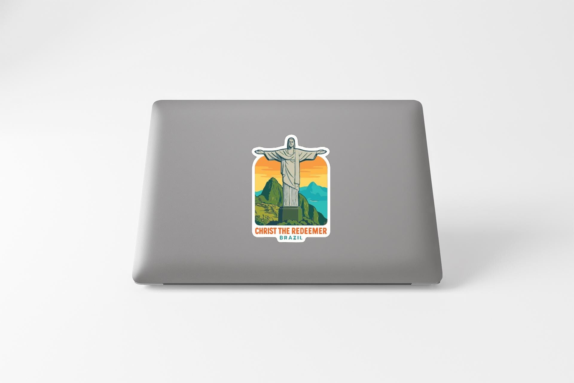 A sticker depicting the Christ the Reformer statue in a mountainous landscape.