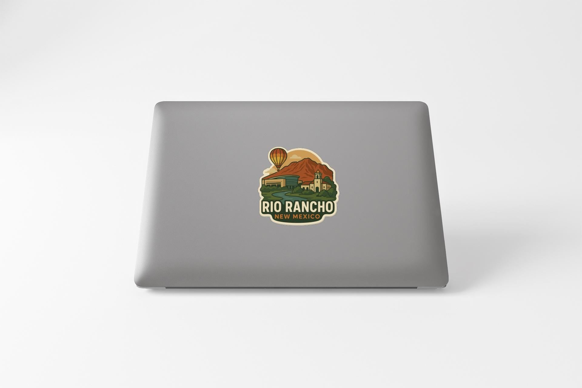 a sticker on the back of a laptop that says "Rio Rancho New Mexico".