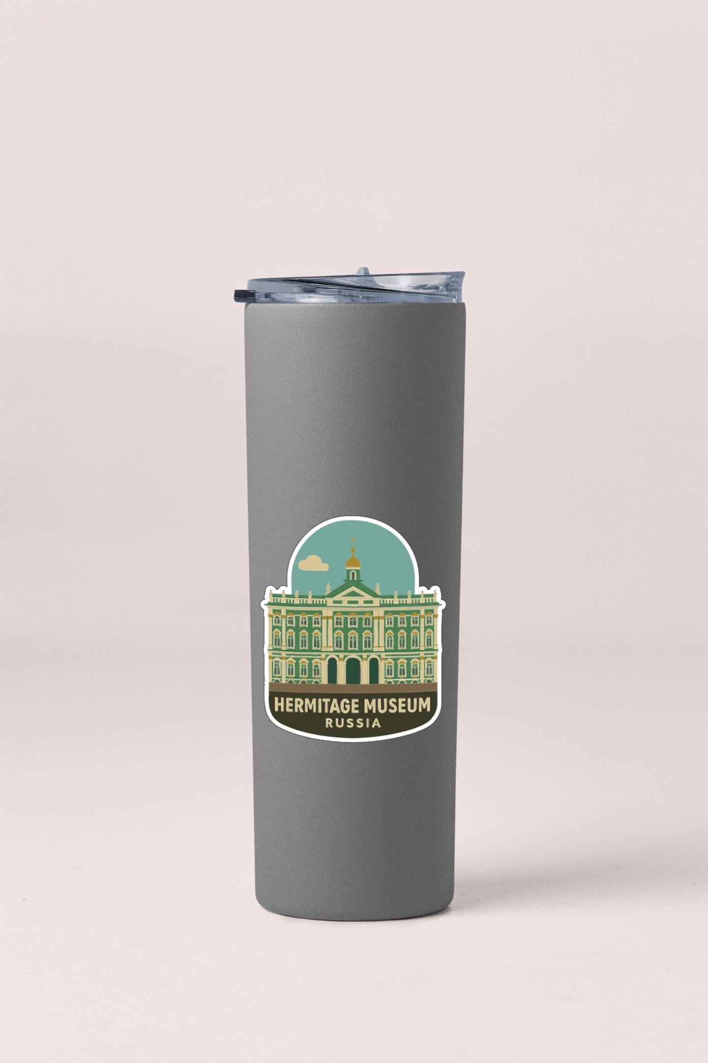 A gray insulated tumbler with a sticker depicting the Hermitage Museum in Russia.