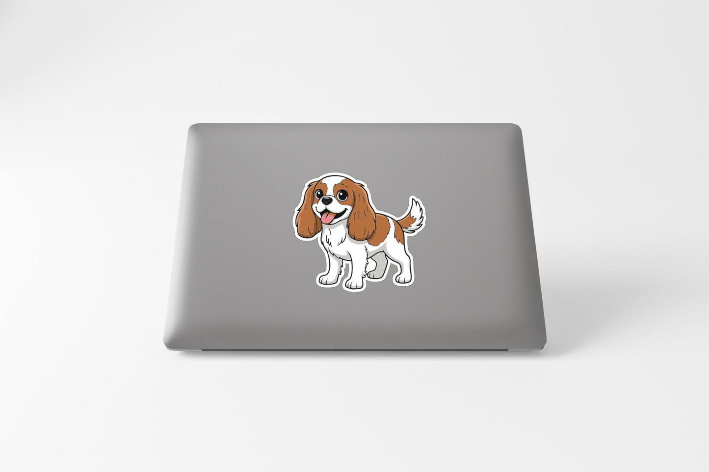 A sticker of a cartoon dog is on the back of a laptop.