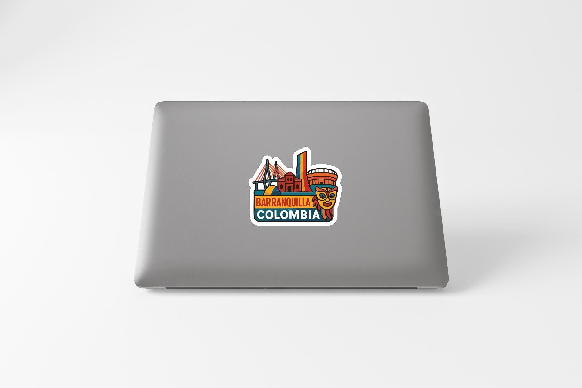 a sticker with a colorful illustration of a cityscape and the text "BARCELONA COLOMBIA" on the back of a laptop.