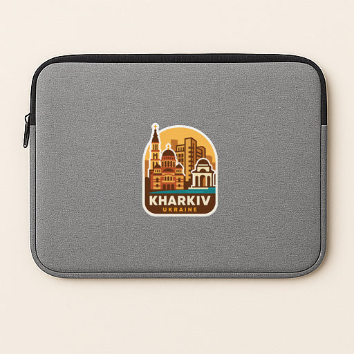 A gray laptop sleeve with a sticker of Kharkiv, Ukraine, printed on it.