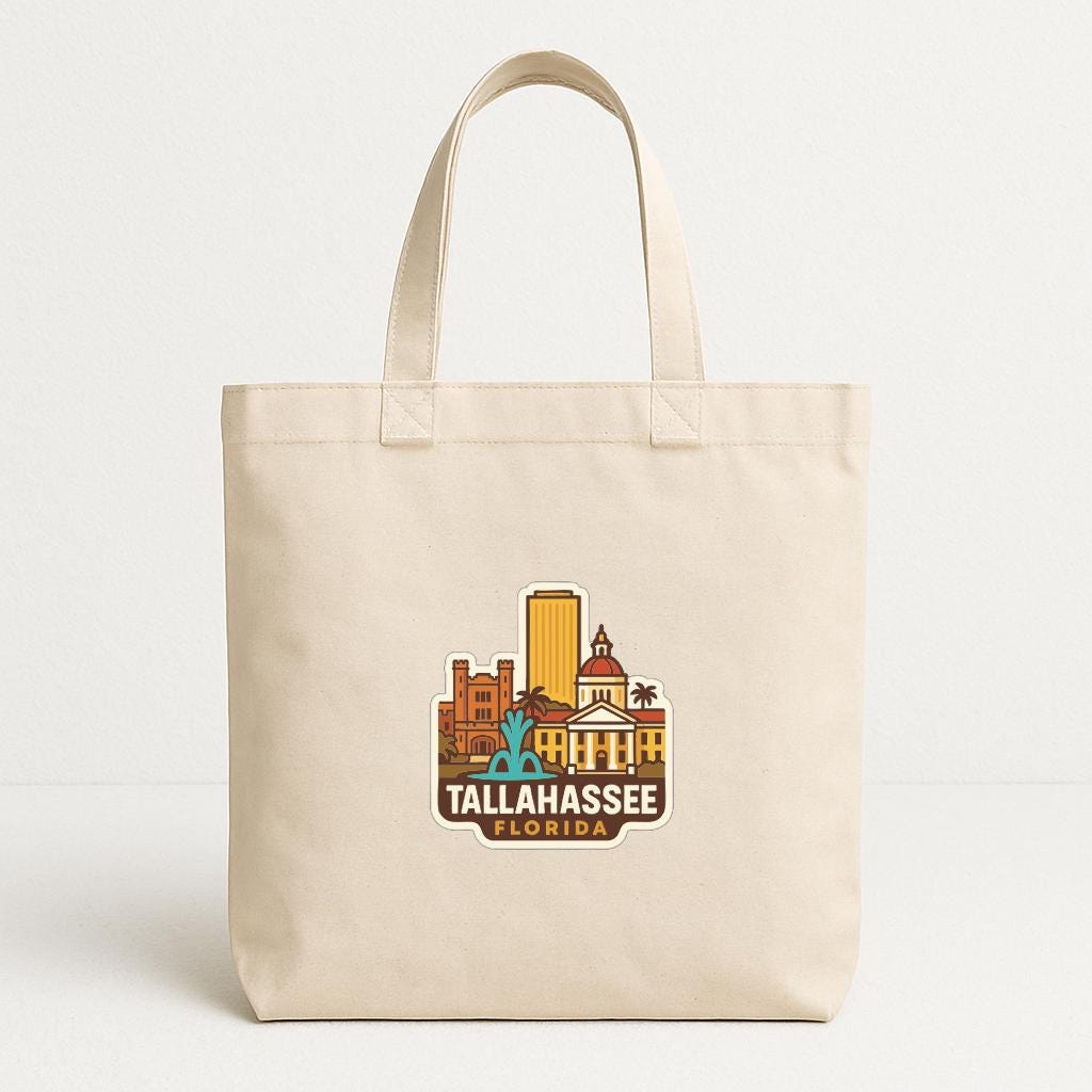 A beige tote bag with a printed design of Tallahassee, Florida, featuring a cityscape and landmarks.