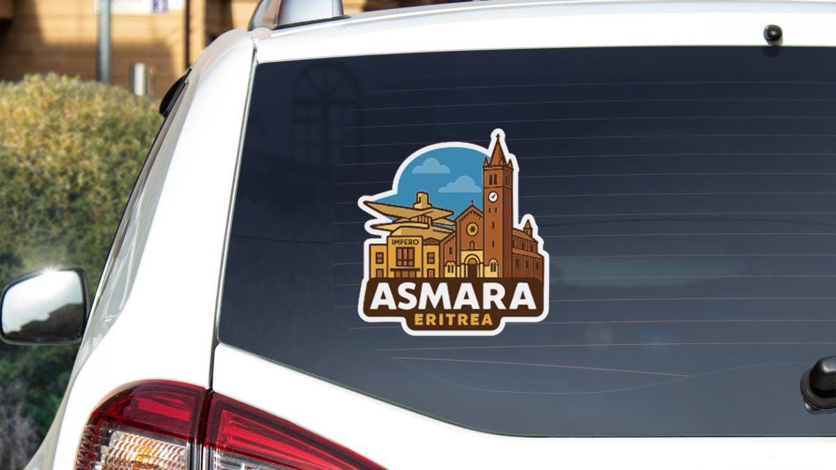 A sticker on the rear window of a car, depicting a cityscape with a church and other buildings.