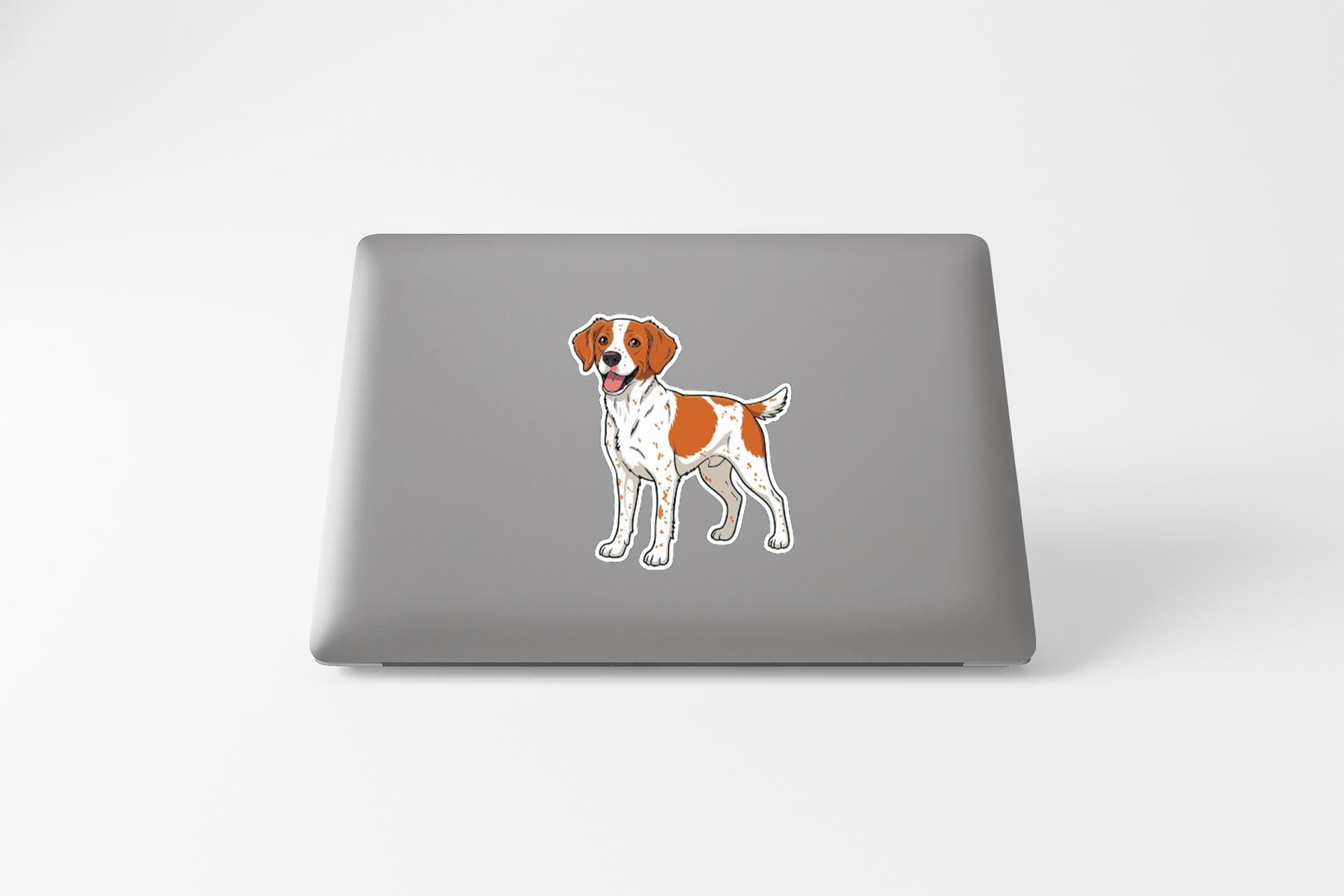 a sticker of a dog on the back of a laptop.