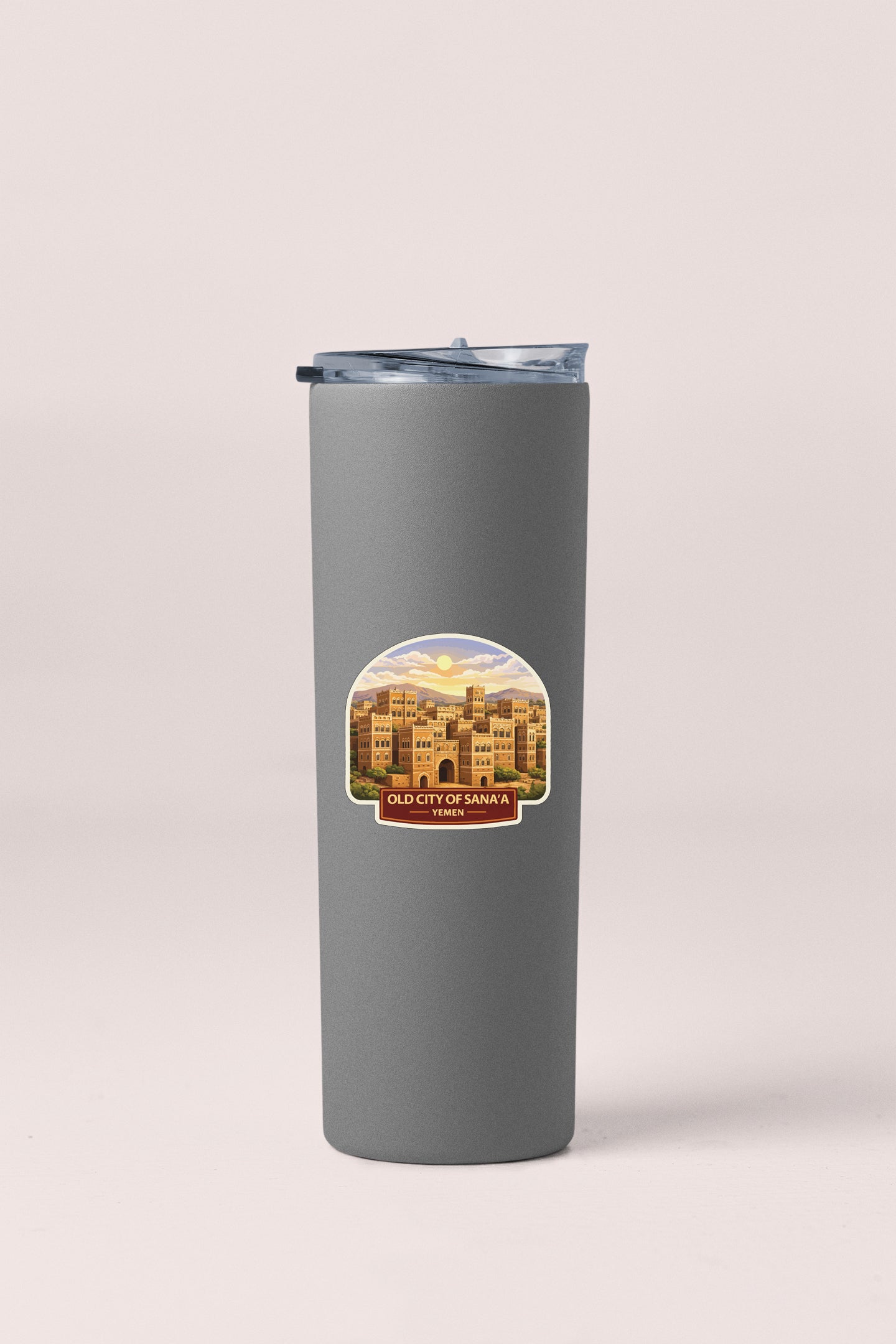A gray insulated tumbler with a sticker depicting a cityscape.