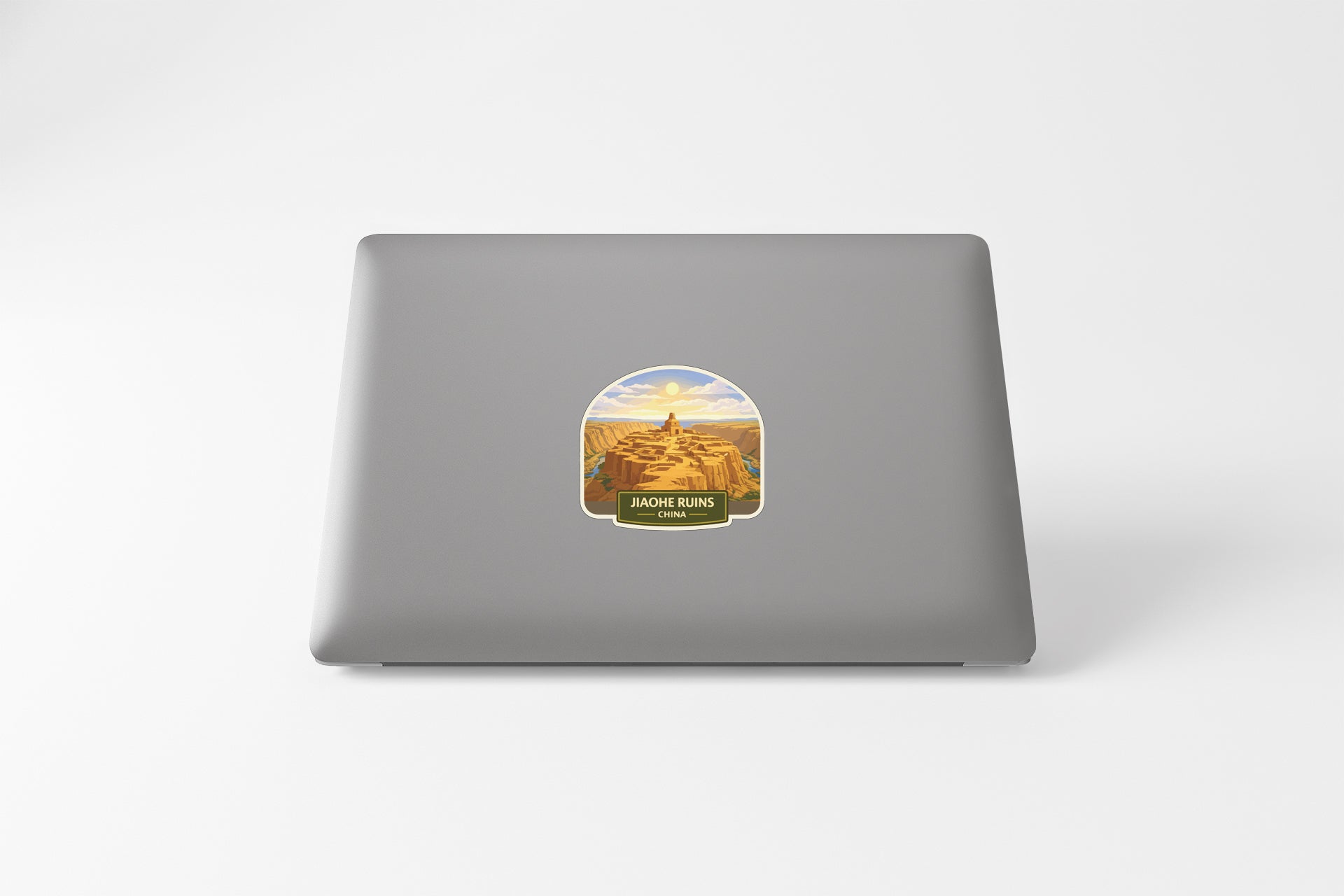 a sticker with a desert landscape on a laptop.
