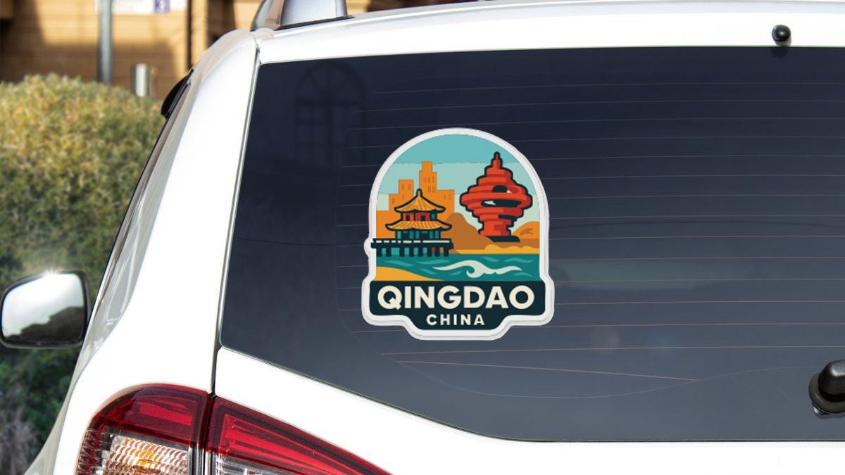 A sticker on the rear window of a car that says "Qingdao China".