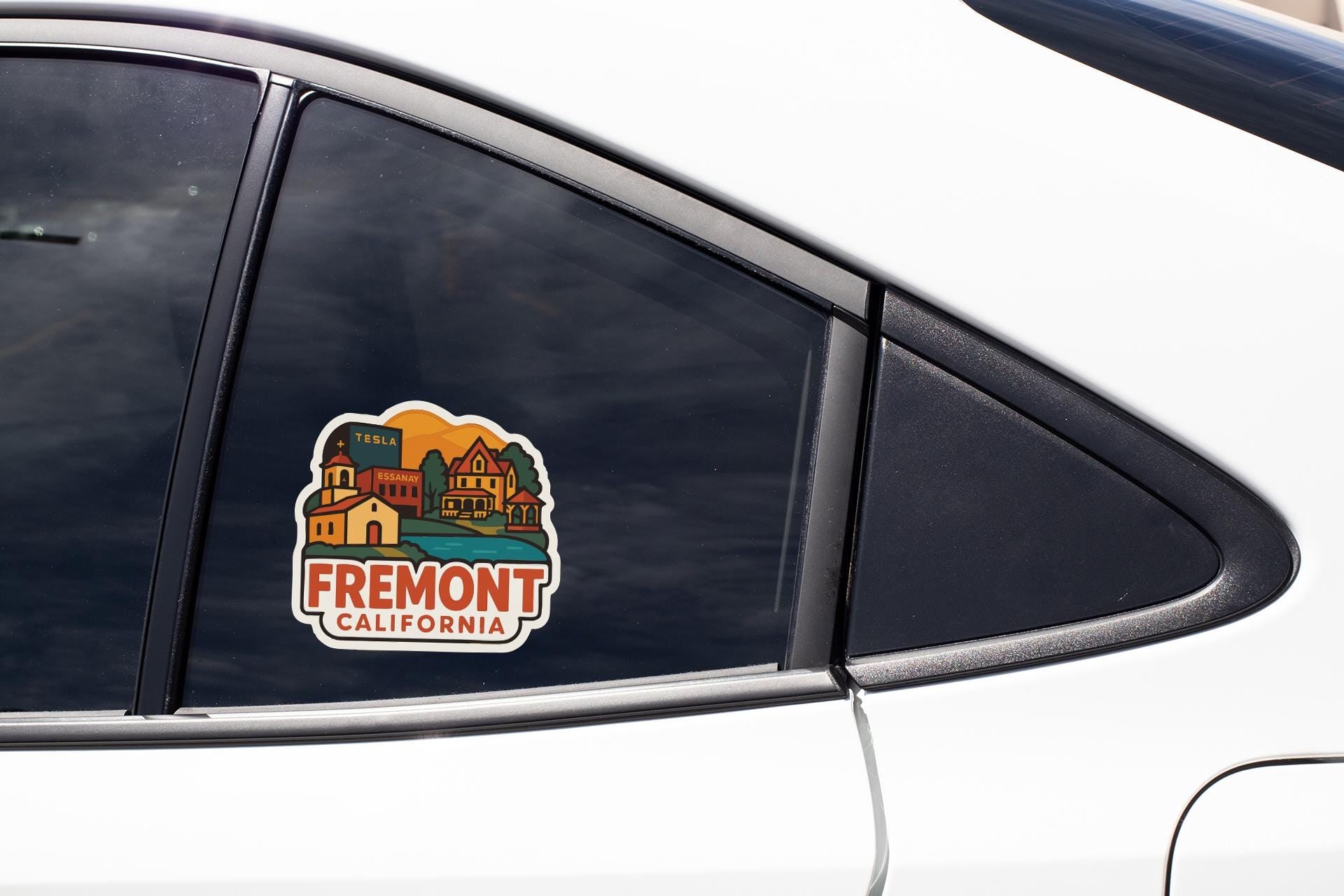 A sticker on the side of a car window that says "Fremont, CA".