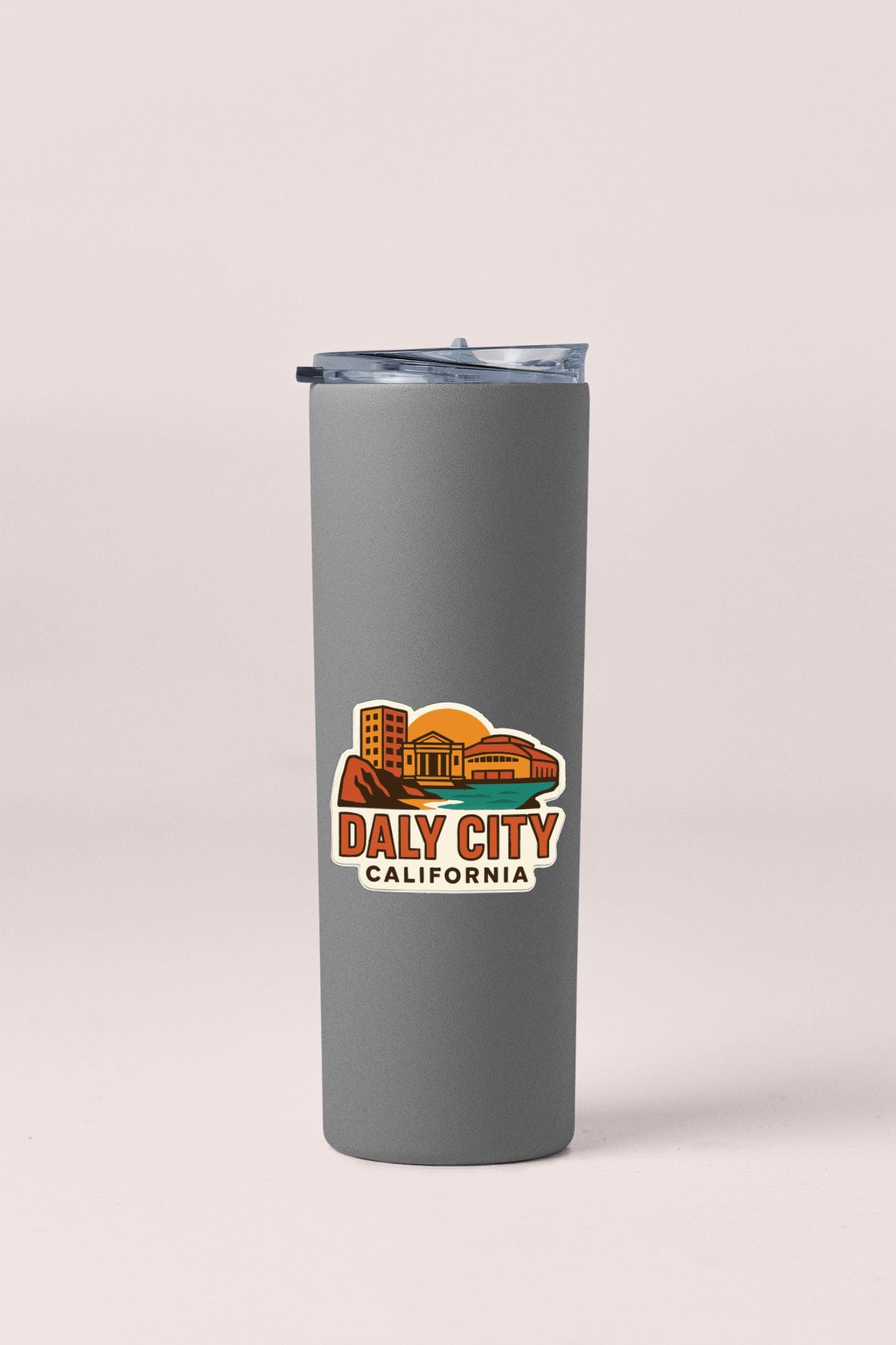 A gray insulated tumbler with a printed logo that says "DAILY CITY CALIFORNIA".