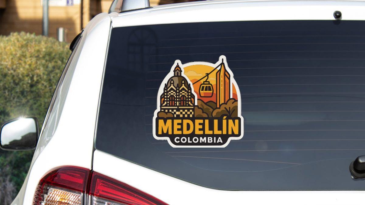 A sticker on the rear window of a car that says "MEDELLÍN COLOMBIA".