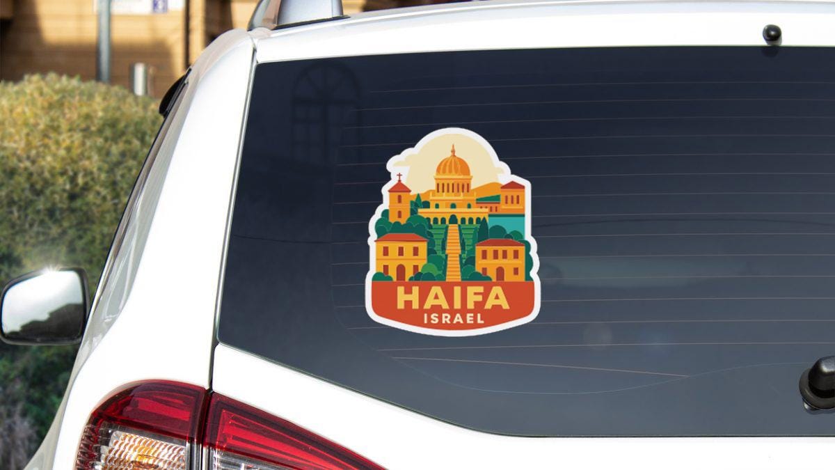 A sticker on the rear window of a car, depicting the Haifa, Israel cityscape.