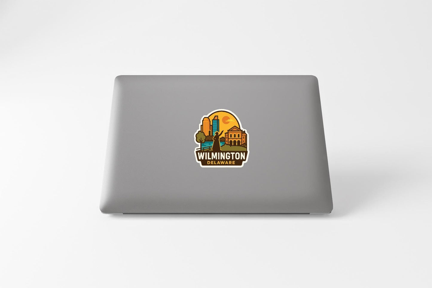 A sticker on the back of a laptop displaying the Wilmington, Delaware logo.