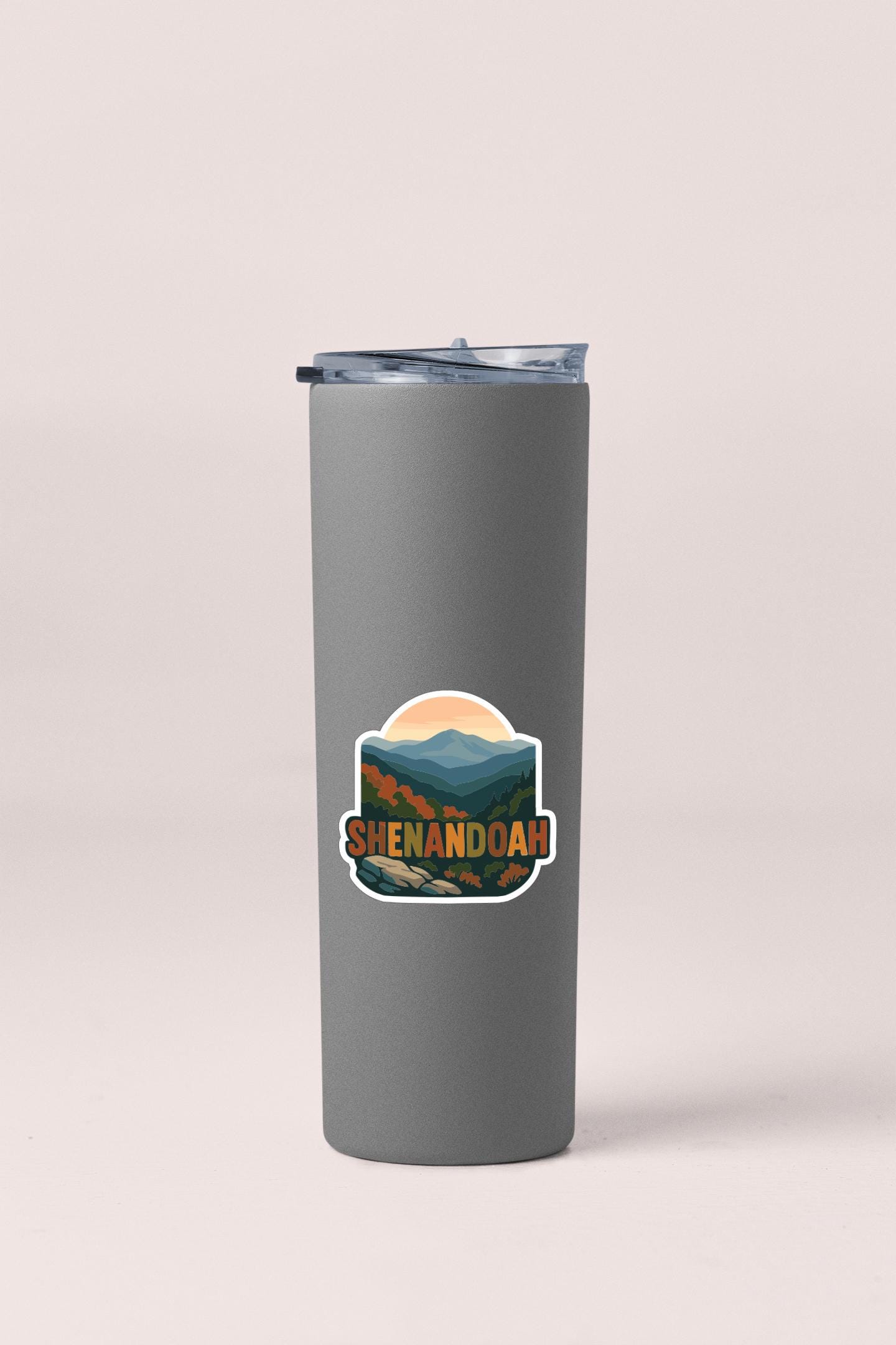 A gray insulated tumbler with a sticker depicting a mountain landscape and the text "Shenandoah".