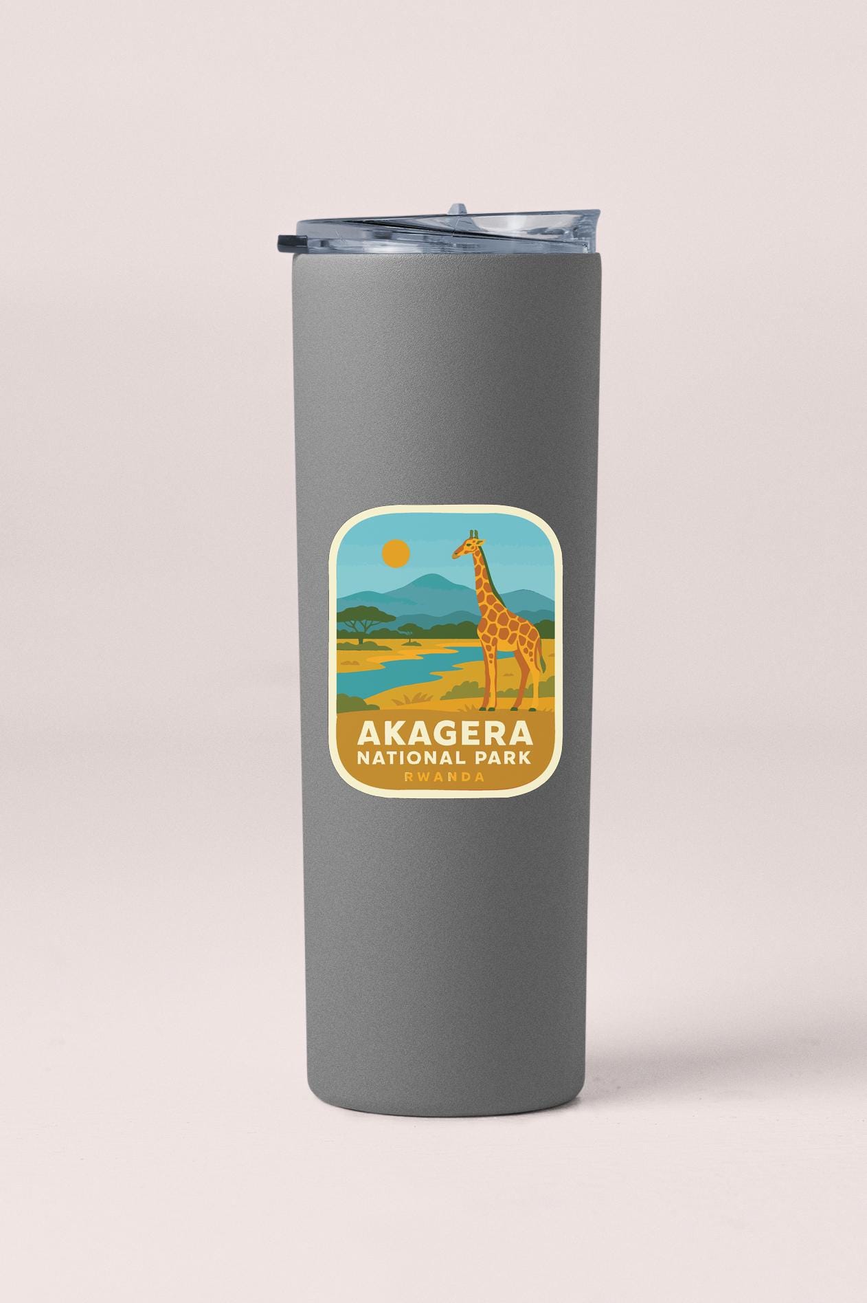 A gray tumbler with a label that says "AKAGERA NATIONAL PARK" and "Rwanda" printed on it.
