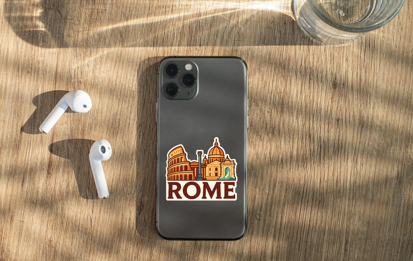a phone with a sticker on it next to ear buds