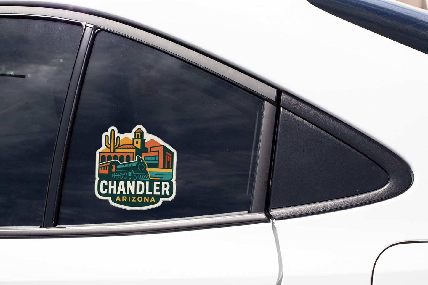 A car window with a sticker on it, featuring a colorful illustration of a cityscape with buildings and a train.