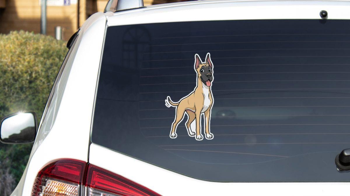 a sticker of a dog on the rear window of a car.