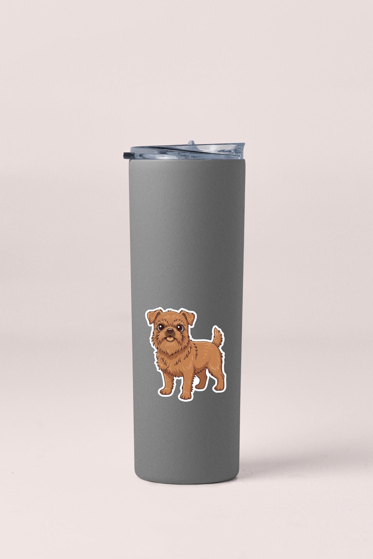 A gray insulated tumbler with a small cartoon illustration of a dog on it.