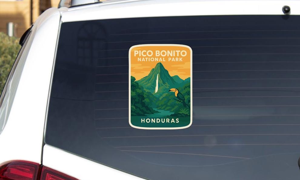 A sticker on the rear window of a car that says "PICO BONITO NATIONAL PARK HONDURAS".