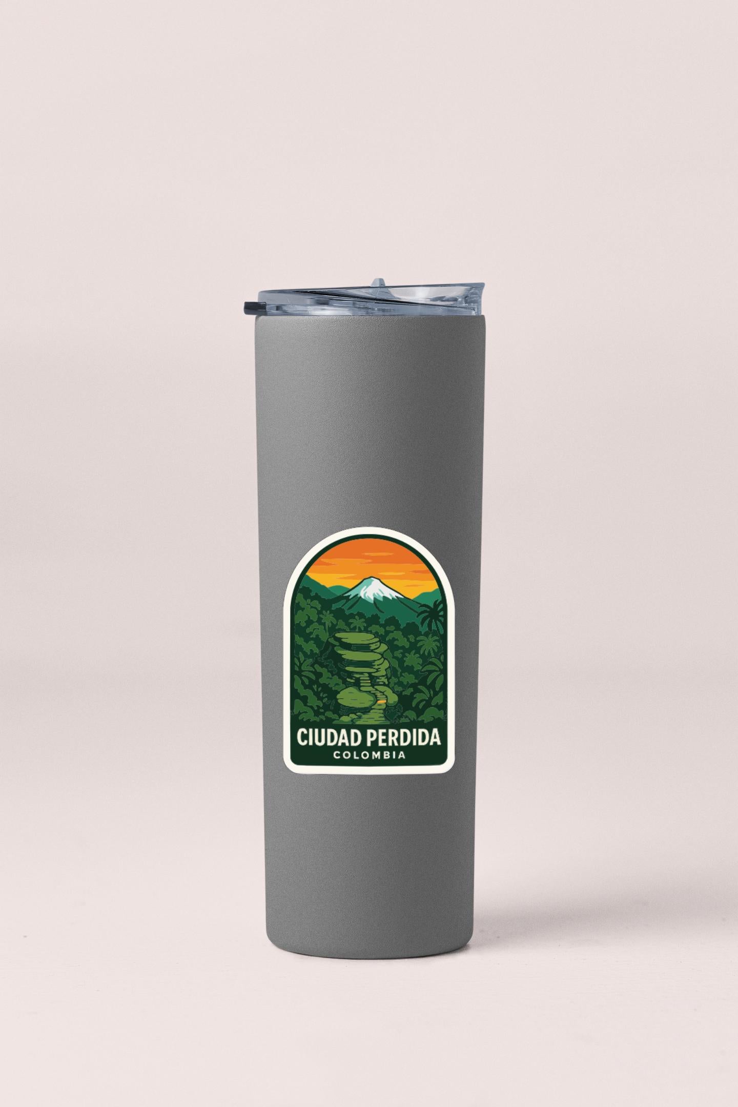 A gray insulated tumbler with a sticker depicting a mountain landscape and the text "CUDA PERDIDA COLOMBIA".