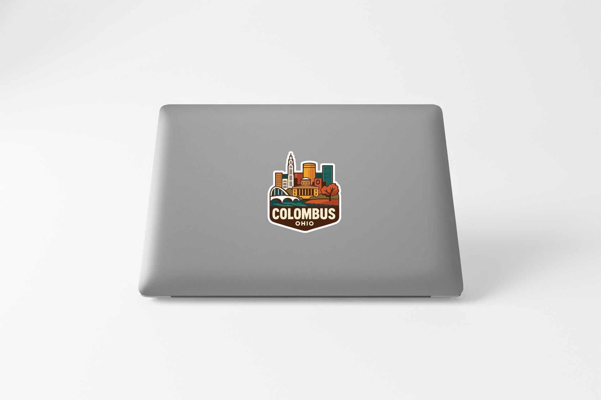 a sticker of the city of Columbus, Ohio, on the back of a laptop.