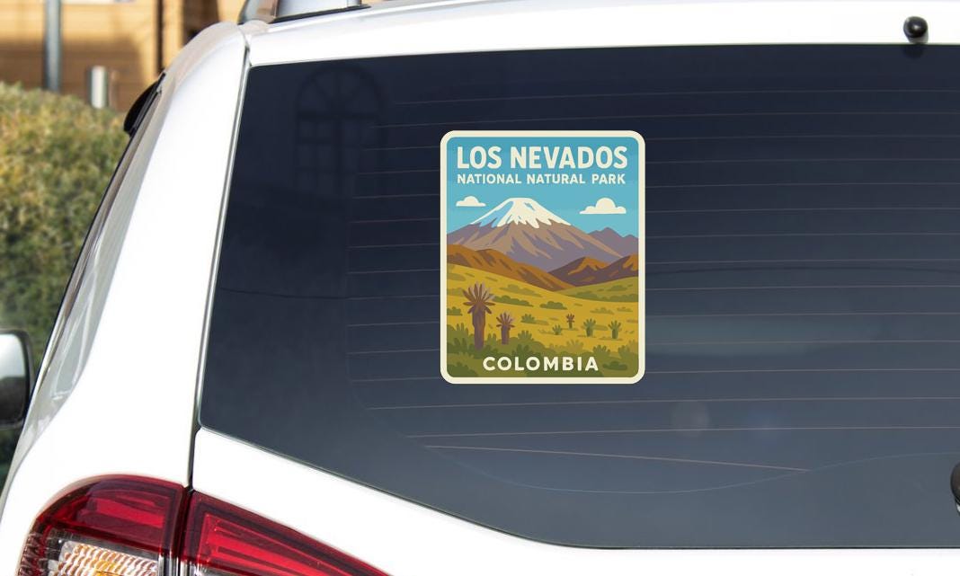 A sticker on the rear window of a car that says "LOS NEVADOS NATURAL PARK COLOMBIA".